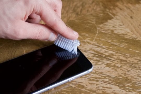 clean dirt from iphone speaker using toothbrush
